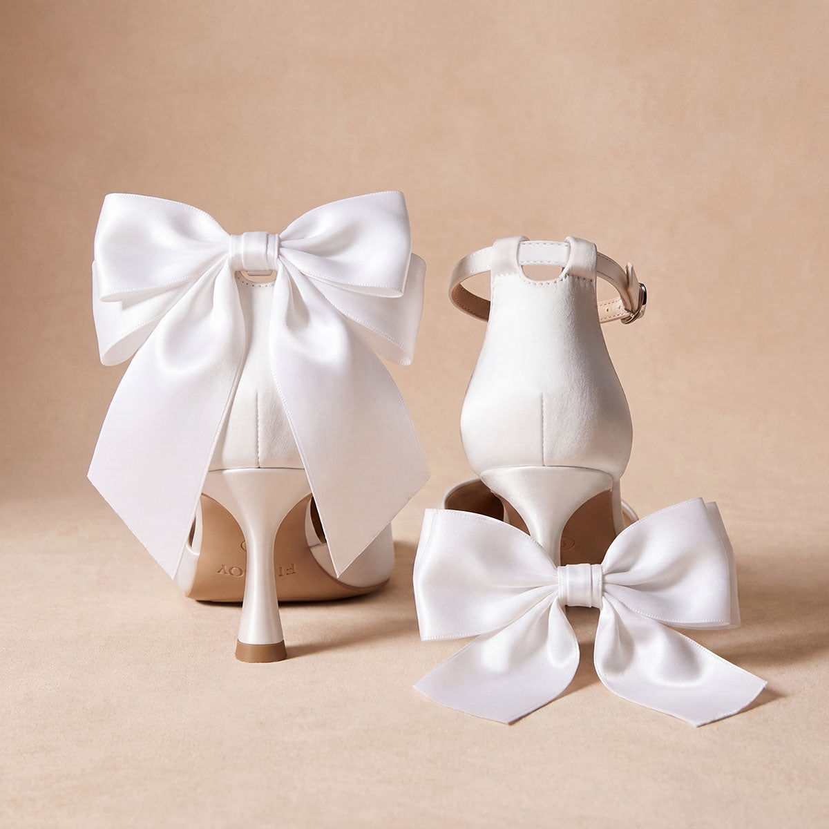 Rear view of white satin pumps showing the heel bows, with a separate bow displayed beside them