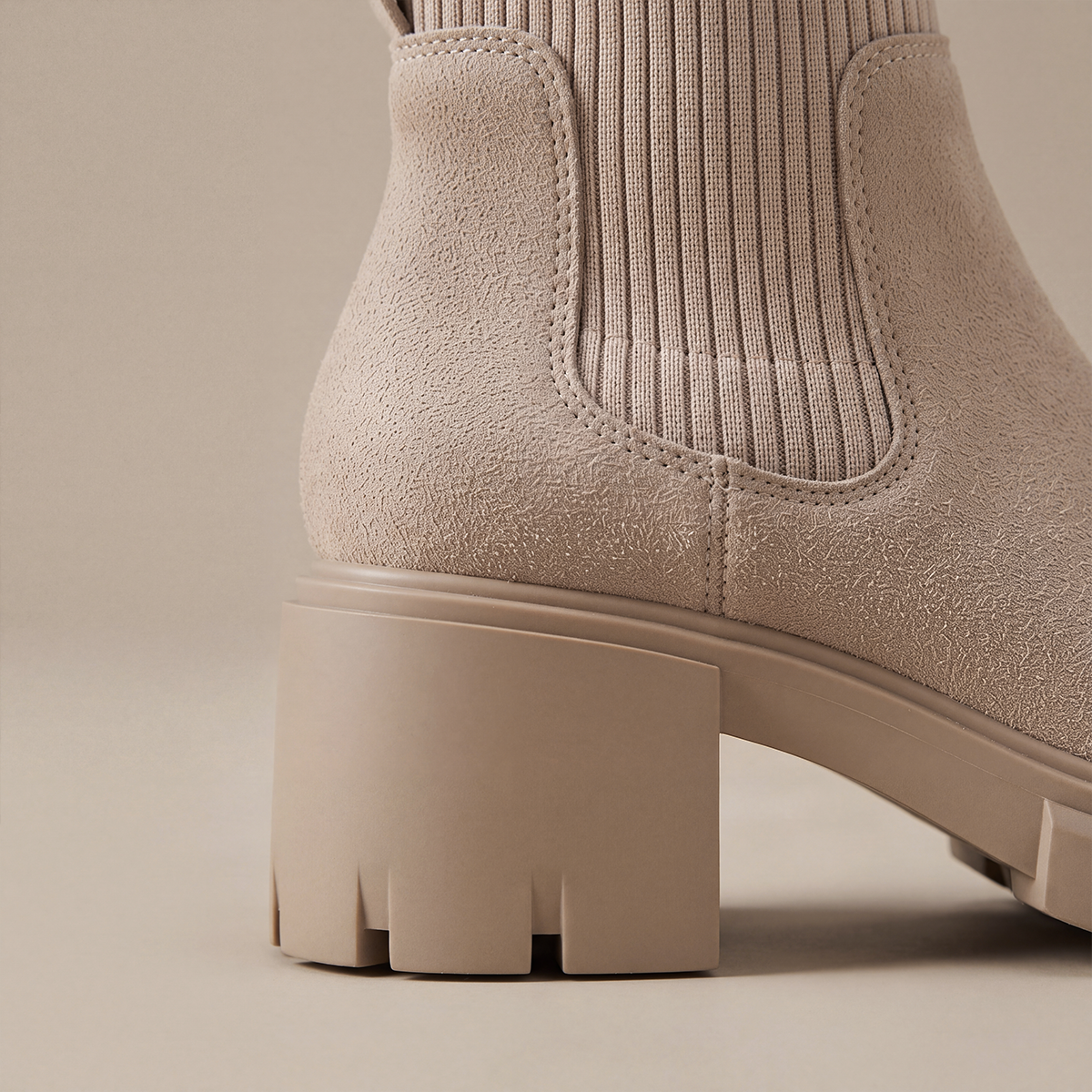 Side view of the chunky block heel on khaki Chelsea boots