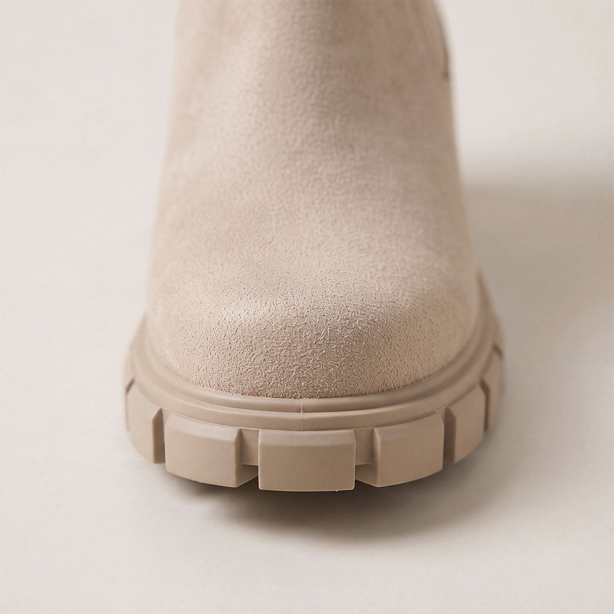 Close-up of the textured upper on khaki Chelsea boots