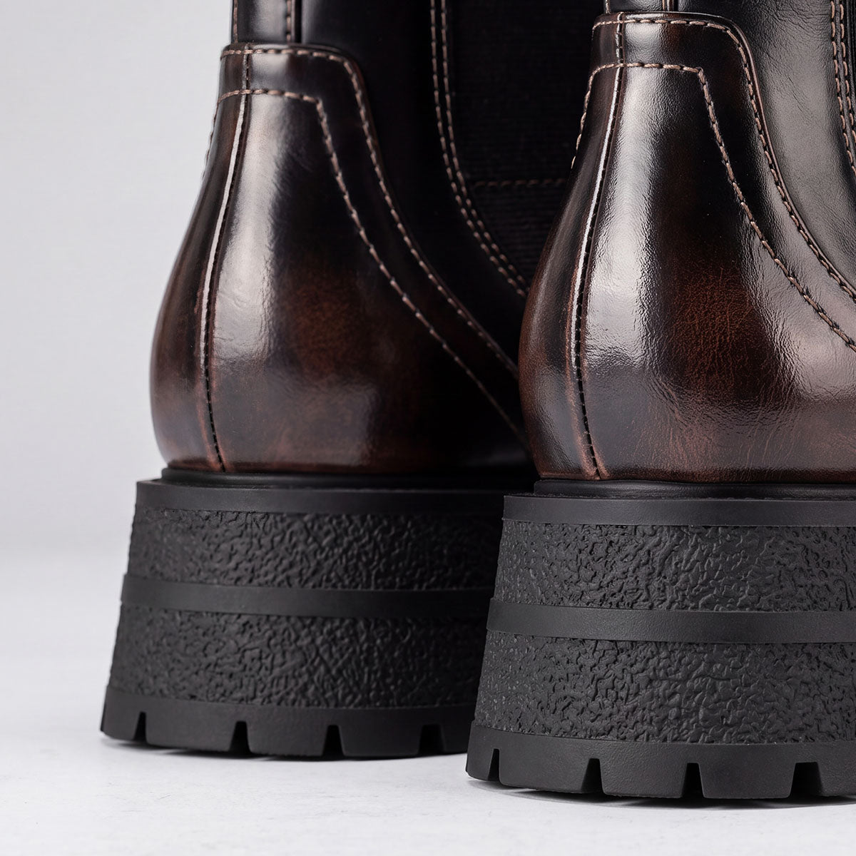 Rear view of black Chelsea boots showing the heel stitching and chunky lug soles