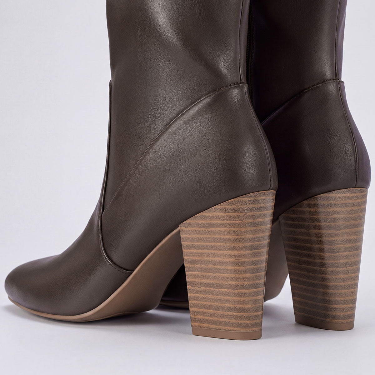 Rear view of chocolate boots showing the stitched ankle panels and wood-look block heels