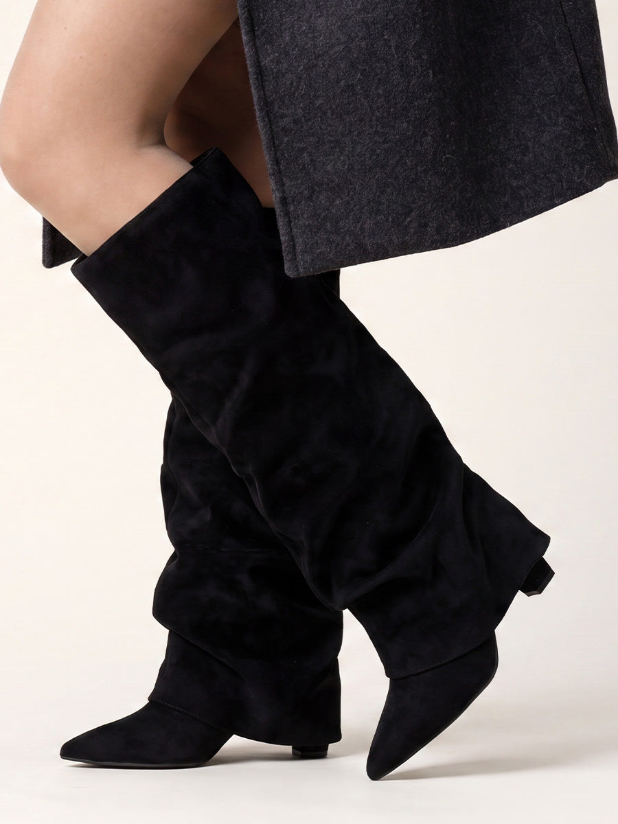 Black suede slouchy pointed-toe boots styled with a charcoal skirt