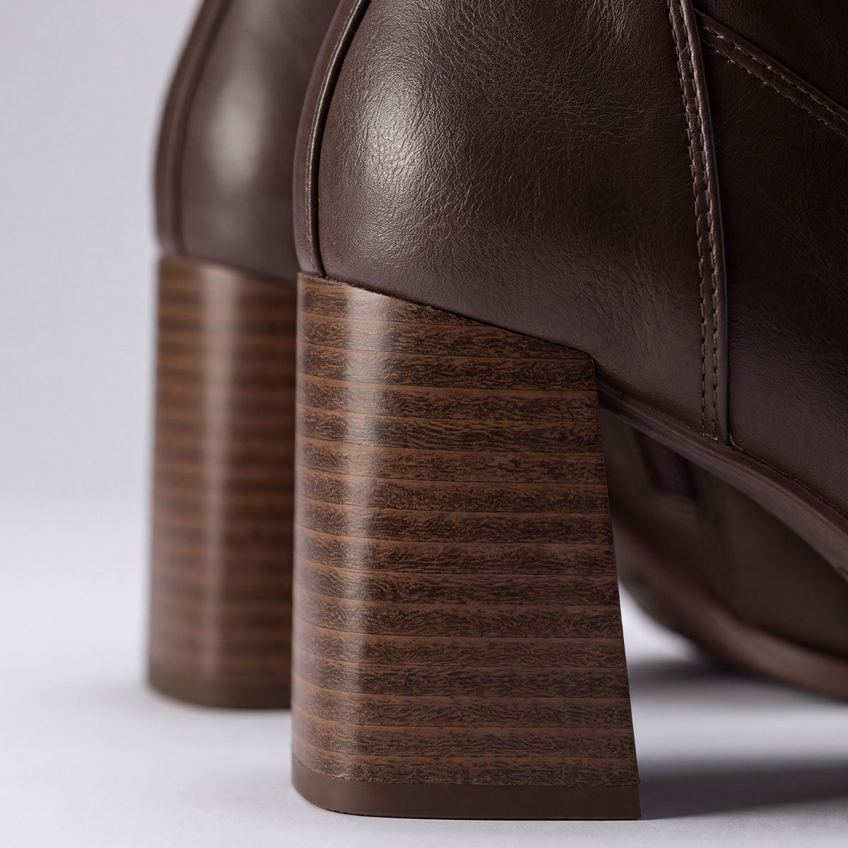 Close-up of the block heels with a layered stripe finish on chocolate ankle boots