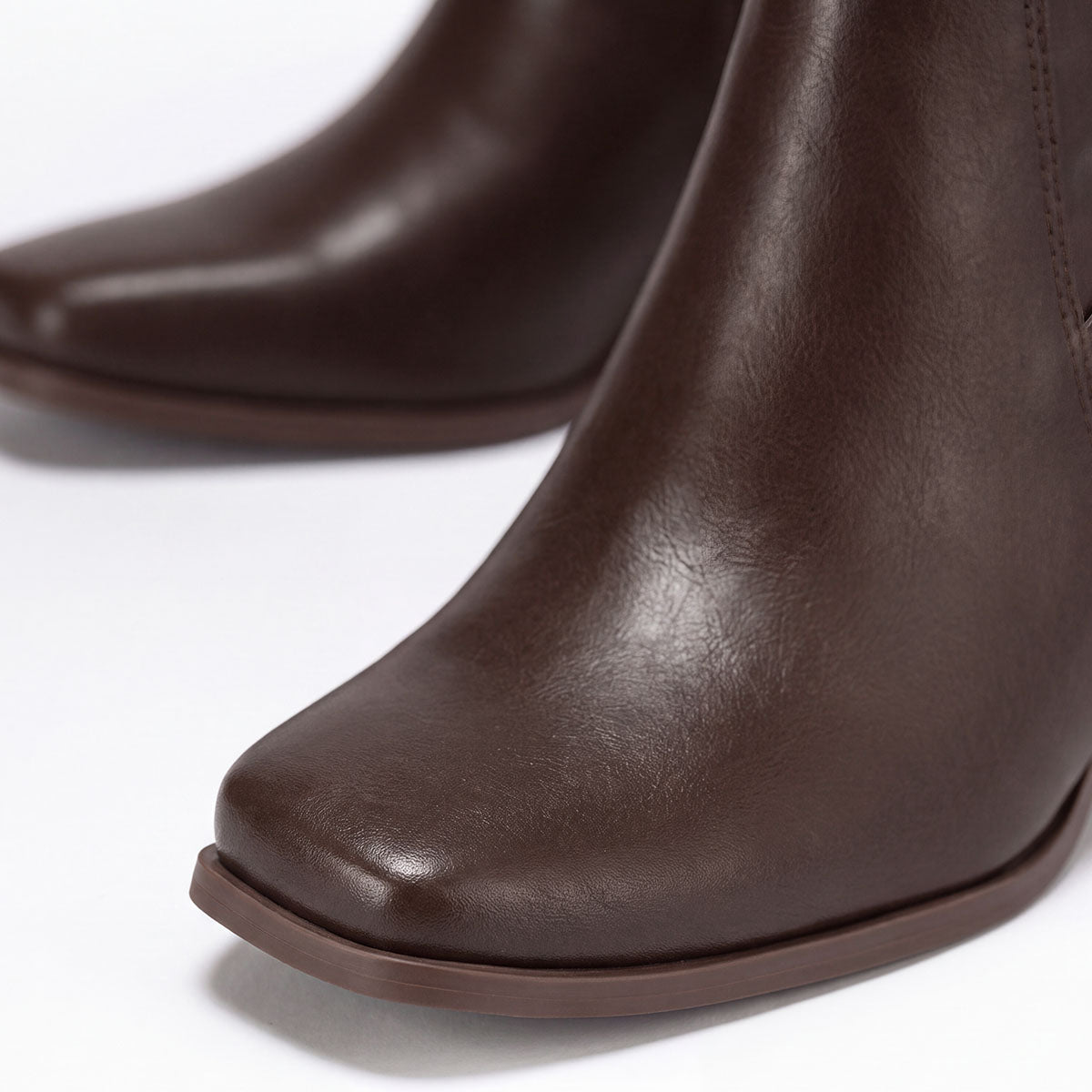 Close-up of the square toes and smooth uppers on chocolate ankle boots